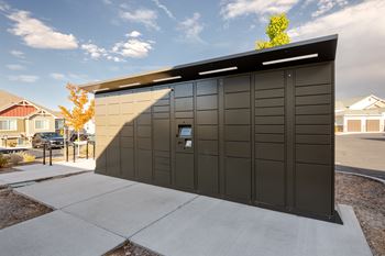 a garage with a black facade and a door on a sidewalk